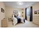Cozy bedroom with accent lighting and a large window with navy patterned curtains at 1060 Arrowhead Ct, Erie, CO 80516