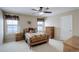 Comfortable bedroom featuring a ceiling fan, natural light, and neutral decor at 1060 Arrowhead Ct, Erie, CO 80516