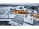 Beautiful single-Gathering home featuring a 2-car garage and charming covered porch, surrounded by a snowy landscape at 1060 Arrowhead Ct, Erie, CO 80516