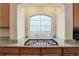 This kitchen features granite countertops and modern stovetop under the arched window at 1060 Arrowhead Ct, Erie, CO 80516