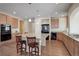 Open kitchen boasts stainless steel appliances, granite countertops, an island with seating, and hardwood floors at 1060 Arrowhead Ct, Erie, CO 80516