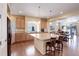 Open kitchen boasts stainless steel appliances, granite countertops, an island with seating, and hardwood floors at 1060 Arrowhead Ct, Erie, CO 80516