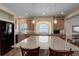 Open kitchen boasts stainless steel appliances, granite countertops, an island with seating, and hardwood floors at 1060 Arrowhead Ct, Erie, CO 80516