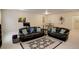 Inviting living room with leather sofas, an area rug, and a small dining table at 1060 Arrowhead Ct, Erie, CO 80516