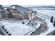 Aerial view of the rear exterior showcasing the patio, seating, and snow-covered yard at 1060 Arrowhead Ct, Erie, CO 80516
