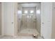 Large tiled shower stall with a glass door and a built-in bench at 1060 Arrowhead Ct, Erie, CO 80516
