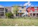A view of the back of the home with a deck and stairs leading down to the yard with a wood fence at 11748 Mill Valley St, Parker, CO 80138