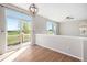 Bright bedroom with hardwood floors, decorative light fixture, windows, and access to the deck at 11748 Mill Valley St, Parker, CO 80138