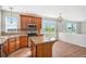 Well-equipped kitchen with wooden cabinets, granite countertops, island, and a large window at 11748 Mill Valley St, Parker, CO 80138