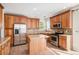 Modern kitchen featuring stainless steel appliances, island, wood cabinets and granite countertops at 11748 Mill Valley St, Parker, CO 80138