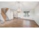 Spacious living room featuring hardwood floors, staircase, decorative light fixture and a large window at 11748 Mill Valley St, Parker, CO 80138