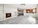 Inviting living room with a cozy fireplace, plush neutral carpet and easy access to the kitchen at 11748 Mill Valley St, Parker, CO 80138