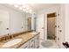 Bathroom with double sink vanity, granite counters, and a shower at 6762 Eagle Pl, Highlands Ranch, CO 80130