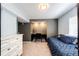 Bedroom with a large dresser, and built-in desk area and a bed with blue linens at 6762 Eagle Pl, Highlands Ranch, CO 80130