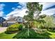 Beautiful home featuring lush landscaping, mature trees, and a well-maintained lawn with a sprinkler system at 6762 Eagle Pl, Highlands Ranch, CO 80130