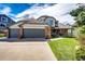 Charming home with brick accents, a two-car garage, and a welcoming front porch surrounded by green lawn at 6762 Eagle Pl, Highlands Ranch, CO 80130