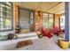 Inviting front porch with comfortable seating, brick columns, and charming decor creating a cozy outdoor space at 6762 Eagle Pl, Highlands Ranch, CO 80130