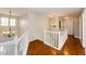 Upstairs hallway with hardwood floors, white railing, and chandelier lighting at 6762 Eagle Pl, Highlands Ranch, CO 80130