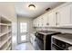 Clean and bright laundry room with modern appliances and shelving at 6762 Eagle Pl, Highlands Ranch, CO 80130