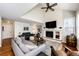 Bright living room with a high ceiling, hardwood floors, and a brick fireplace at 6762 Eagle Pl, Highlands Ranch, CO 80130
