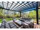 Inviting outdoor patio area with pergola, comfortable seating, and lush landscaping at 6762 Eagle Pl, Highlands Ranch, CO 80130