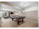 Finished basement featuring a pool table, tv, couch, and sliding door access at 19884 E Villanova Pl, Aurora, CO 80013