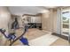 Basement workout area with exercise bike, weight bench, wet bar and walkout access at 19884 E Villanova Pl, Aurora, CO 80013