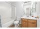 Bright bathroom with white tub, toilet, sink, and light wood vanity at 19884 E Villanova Pl, Aurora, CO 80013