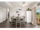 Bright dining room featuring modern table with seating, wood flooring, and sliding glass door to deck at 19884 E Villanova Pl, Aurora, CO 80013