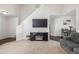 Spacious living room featuring plush carpeting, vaulted ceilings, fireplace and open staircase at 19884 E Villanova Pl, Aurora, CO 80013
