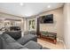 A living room featuring comfortable seating, a TV, and easy access to the outdoors at 19884 E Villanova Pl, Aurora, CO 80013
