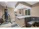 View of the basement wet bar, bench seating, and exercise equipment at 19884 E Villanova Pl, Aurora, CO 80013