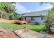 Well-maintained backyard featuring a wooden deck, privacy fence, and lush green lawn at 354 Willowick Cir, Highlands Ranch, CO 80129