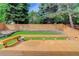 This backyard features a wood deck, wooden fence, green grass and several trees at 354 Willowick Cir, Highlands Ranch, CO 80129