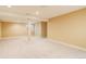 Finished basement featuring carpeting and a support column at 354 Willowick Cir, Highlands Ranch, CO 80129