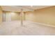 Large, open basement area with carpeting and a support column at 354 Willowick Cir, Highlands Ranch, CO 80129