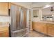 Well-lit kitchen featuring stainless steel refrigerator and lots of cabinet space at 354 Willowick Cir, Highlands Ranch, CO 80129