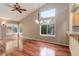 Sunlit living room boasts gleaming hardwood floors and a vaulted ceiling with fan at 354 Willowick Cir, Highlands Ranch, CO 80129
