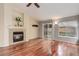 Living room features hardwood floors, fireplace, sliding glass door to patio, and lots of light at 354 Willowick Cir, Highlands Ranch, CO 80129
