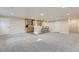 Basement with a modern bar area featuring a light countertop, wooden cabinets and shelving and seating, ideal for gatherings at 537 N 48Th Ave, Brighton, CO 80601