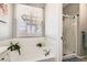Bright bathroom with soaking tub, glass shower, and white tile at 537 N 48Th Ave, Brighton, CO 80601