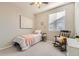 Well-lit bedroom with rocking chair, ceiling fan, and neutral tones at 537 N 48Th Ave, Brighton, CO 80601