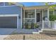 Inviting porch featuring gray siding, white railing, and a garage at 537 N 48Th Ave, Brighton, CO 80601
