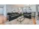 Living room featuring comfortable leather sofas, hardwood flooring, and modern decor at 537 N 48Th Ave, Brighton, CO 80601
