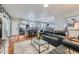 Open living room with hardwood floors, modern kitchen, and comfortable leather seating at 537 N 48Th Ave, Brighton, CO 80601