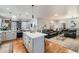 Open-concept living space connecting the kitchen and Gathering room with hardwood floors and natural light at 537 N 48Th Ave, Brighton, CO 80601