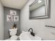 Stylish powder room with a round vessel sink, matte black faucet, framed mirror, and calming gray walls at 537 N 48Th Ave, Brighton, CO 80601