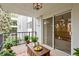 Cozy balcony with table, plants, and sliding glass doors at 2325 S Linden Ct # 206, Denver, CO 80222