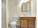 Bright bathroom with a wood vanity, white sink, and tile flooring at 2325 S Linden Ct # 206, Denver, CO 80222