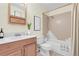 Cozy bathroom with a framed mirror, decorative plants, and shower over the bath at 2325 S Linden Ct # 206, Denver, CO 80222